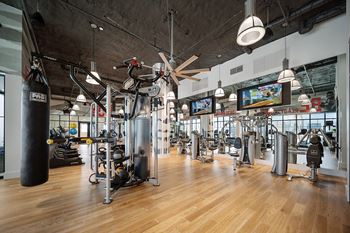 a large fitness room with cardio equipment and flat screen tvs at Altis Grand Central, Tampa, 33606